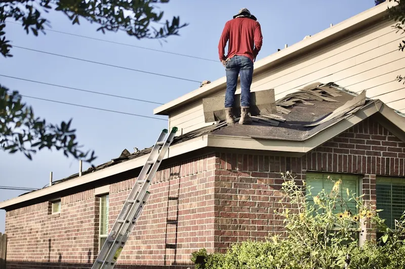 Professional roofer working on a residential roof in Riverbank